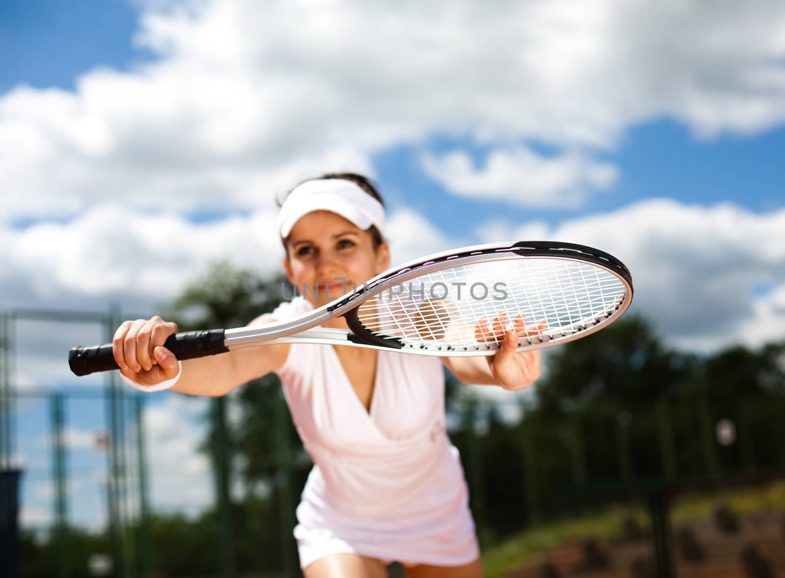 Young woman tennis player on the court