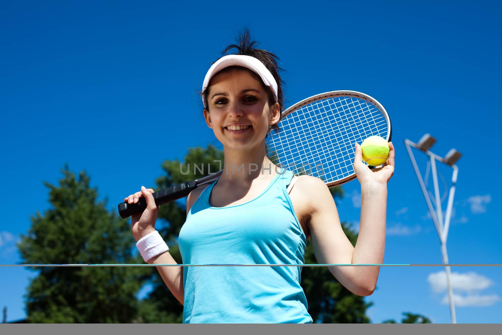 Young woman playing tennis, summertime saturated theme