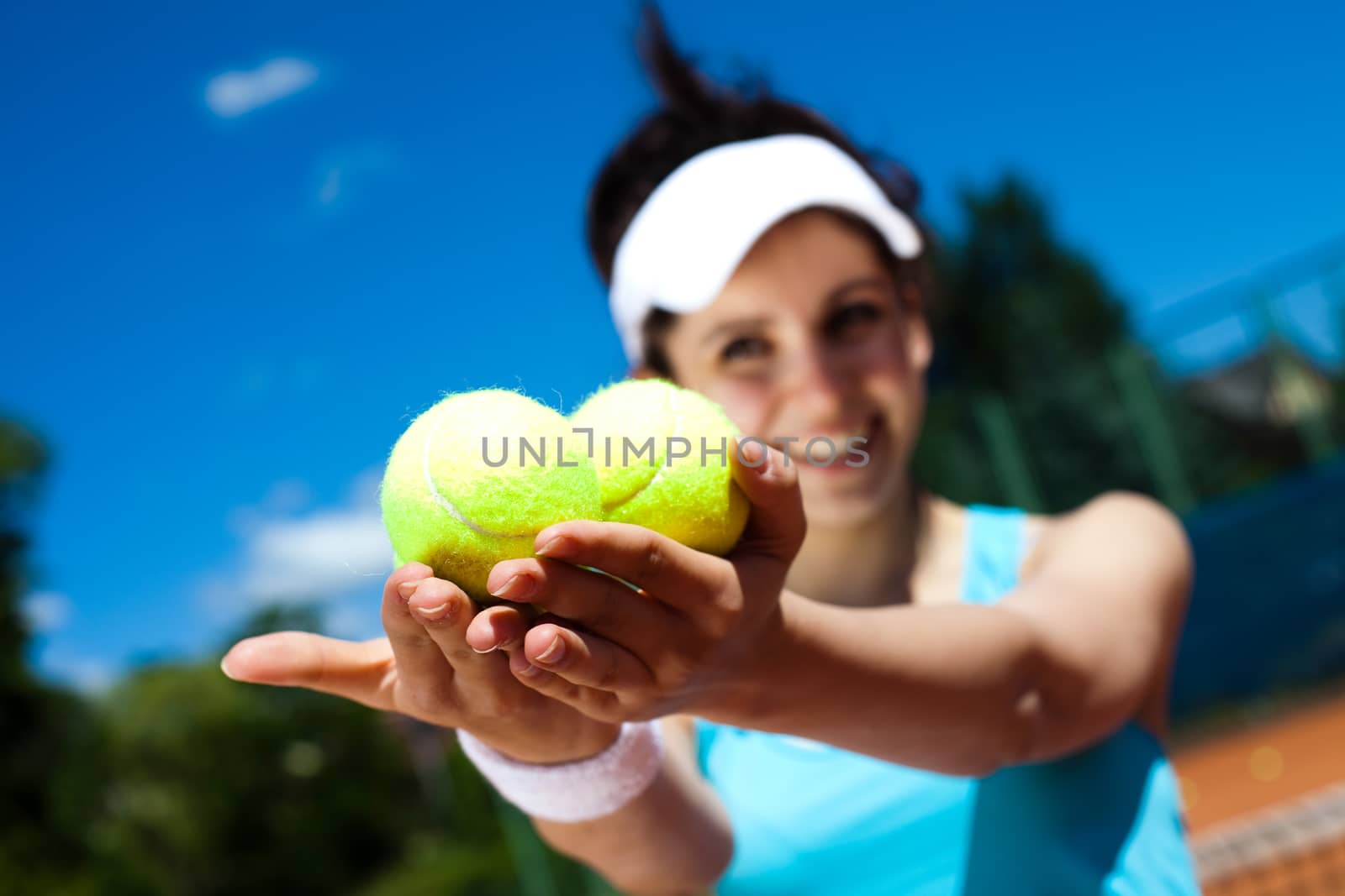 Young woman playing tennis, summertime saturated theme