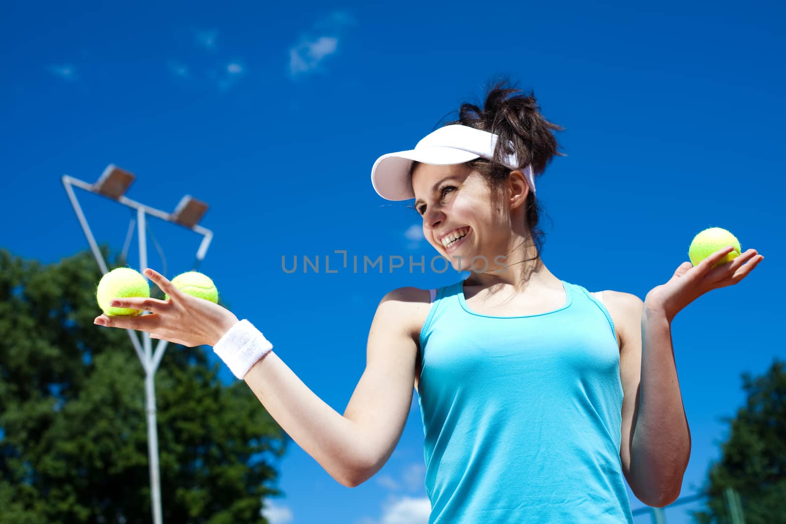 Young woman playing tennis, summertime saturated theme