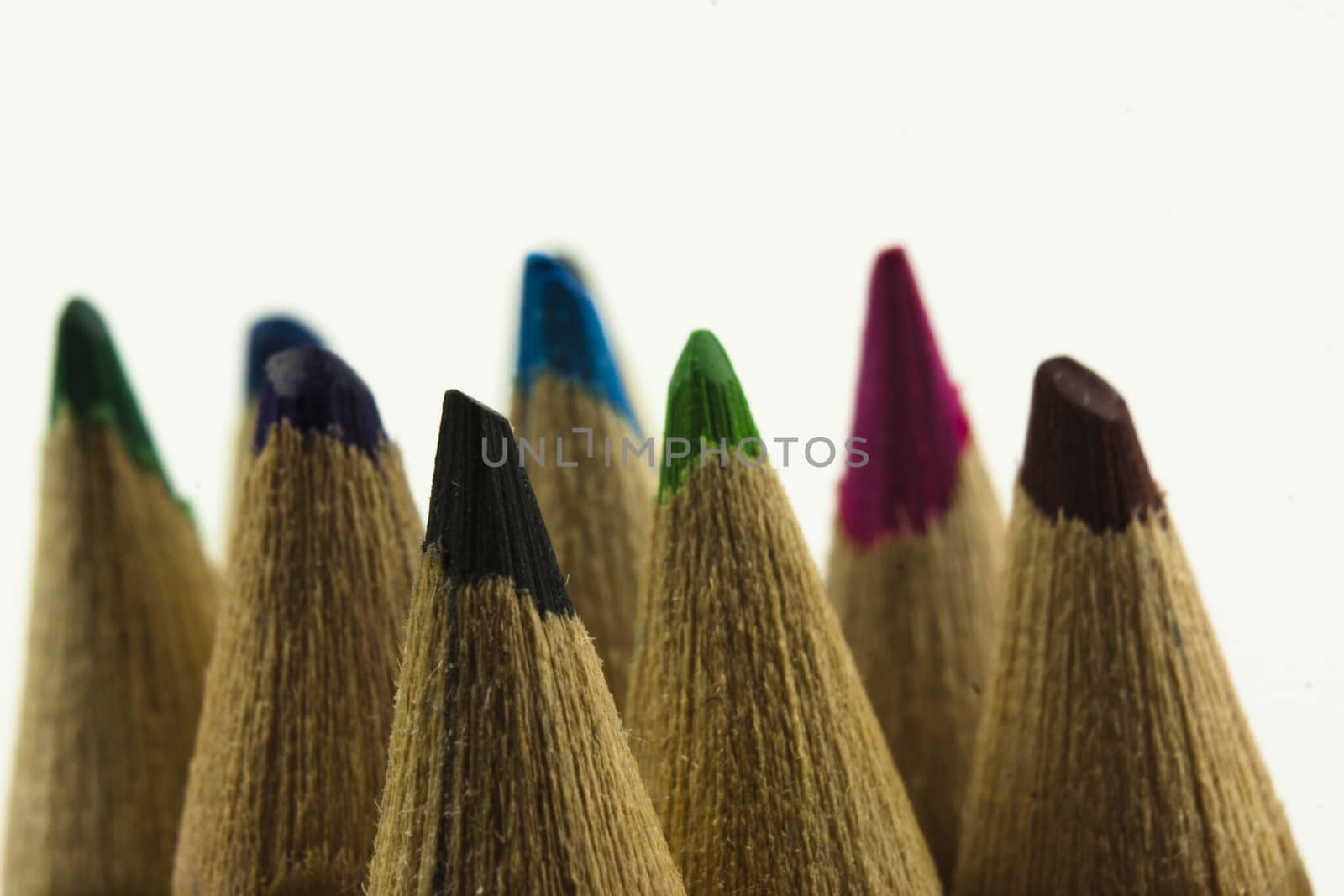 Close f of coloured pencils against a wooden background