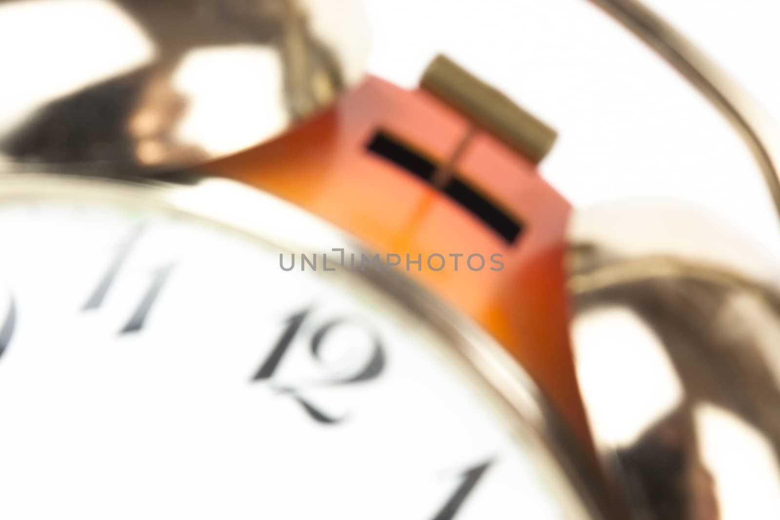 Close up of an alarm clock on a white background - blurred