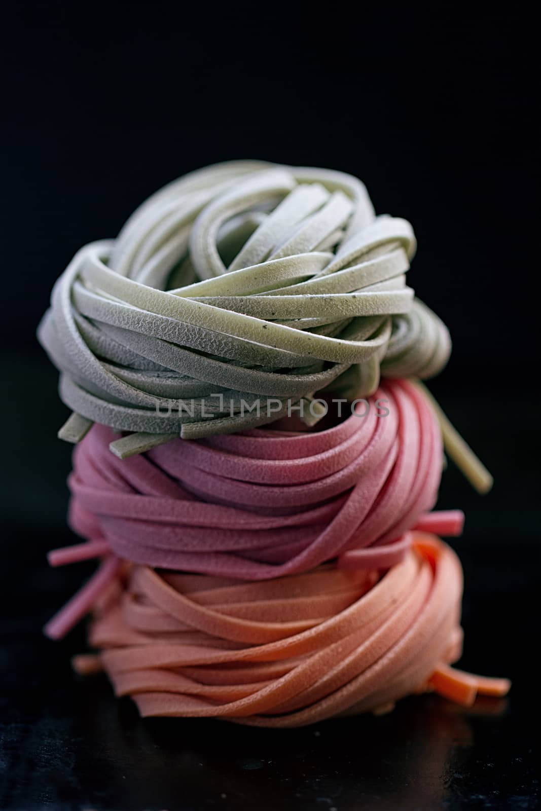 colorful pasta tagliatelle on a black background