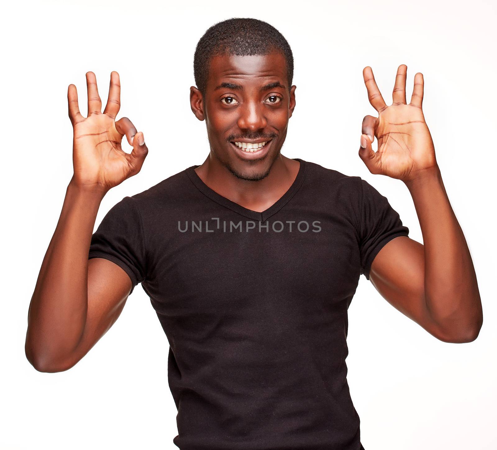 Closeup portrait of handsome young black african smiling man, showing the fingers of the hand, all ok, isolated on white background. Positive human emotions