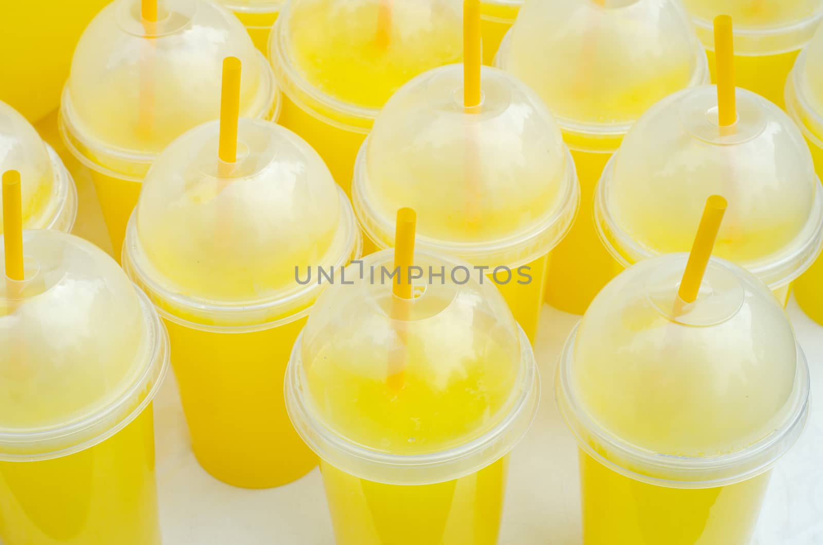 Yellow lemonade plastic cups with tubes and flares