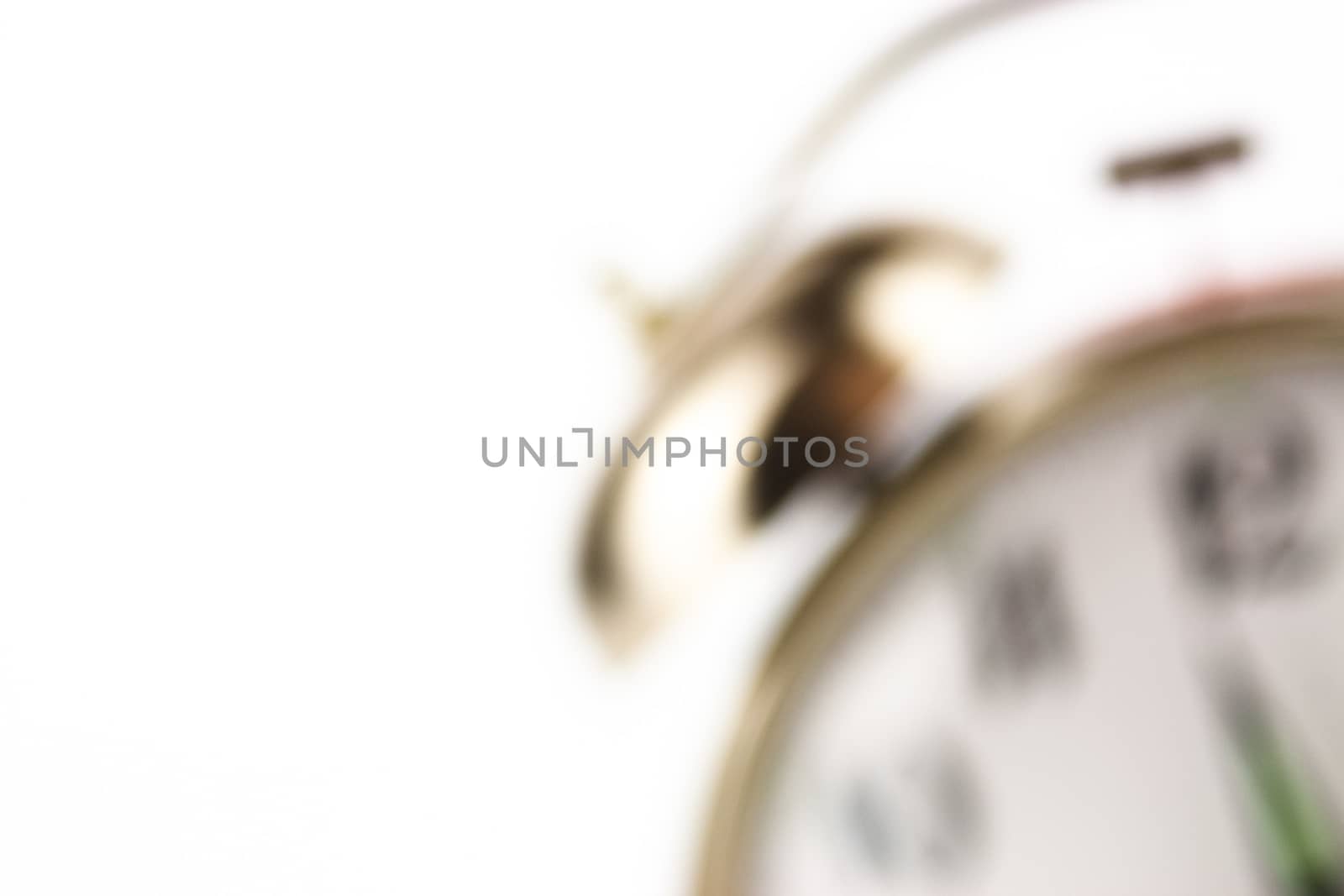 Close up of an alarm clock on a white background - blurred
