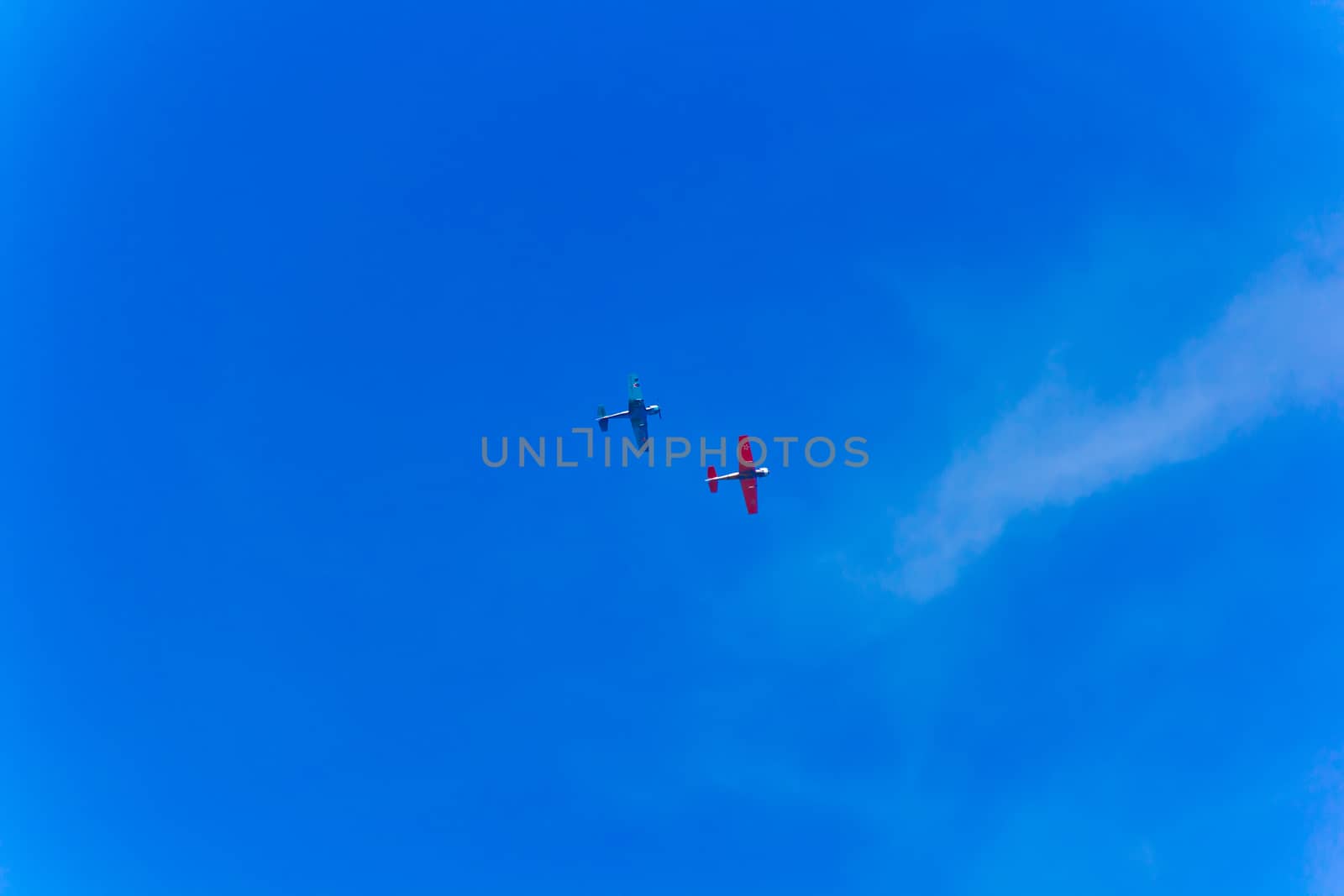 Photo of two flying planes in blue sky