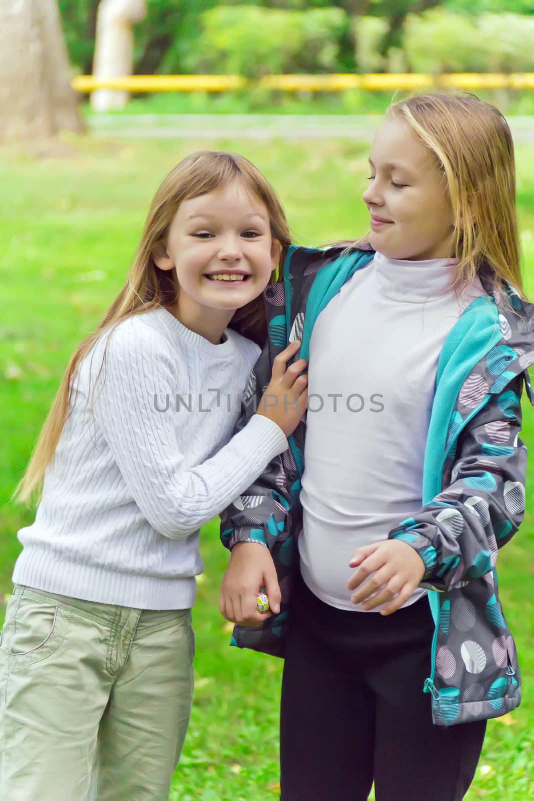 Photo of two playing girls in summer