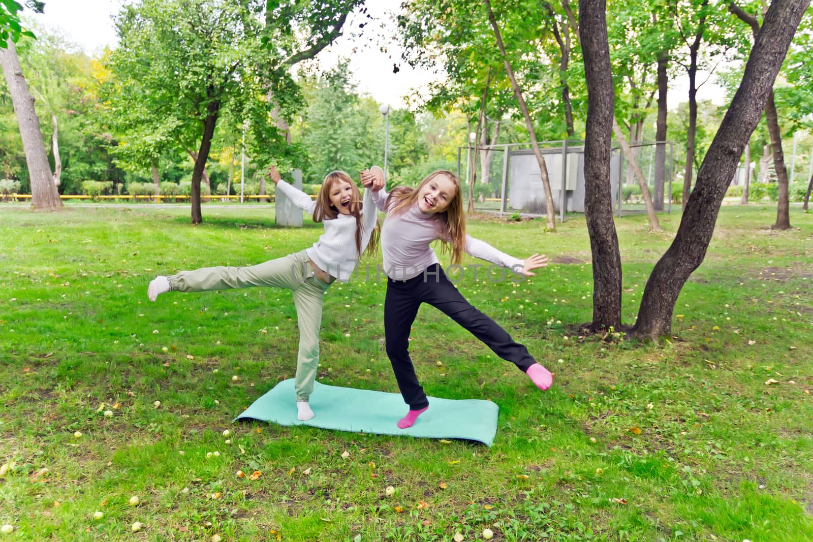 Photo of two playing girls in summer