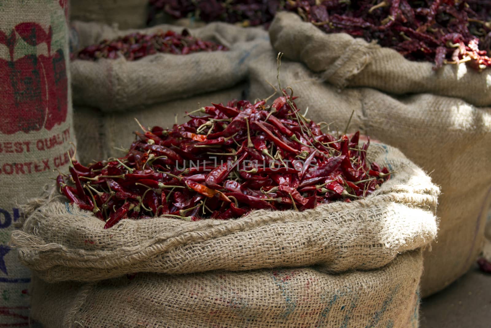 Dried red chili peppers in sacks in India Goa by mcherevan