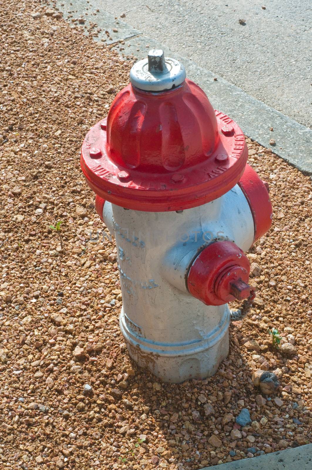 Red fire hydrant in urban area on side of road.