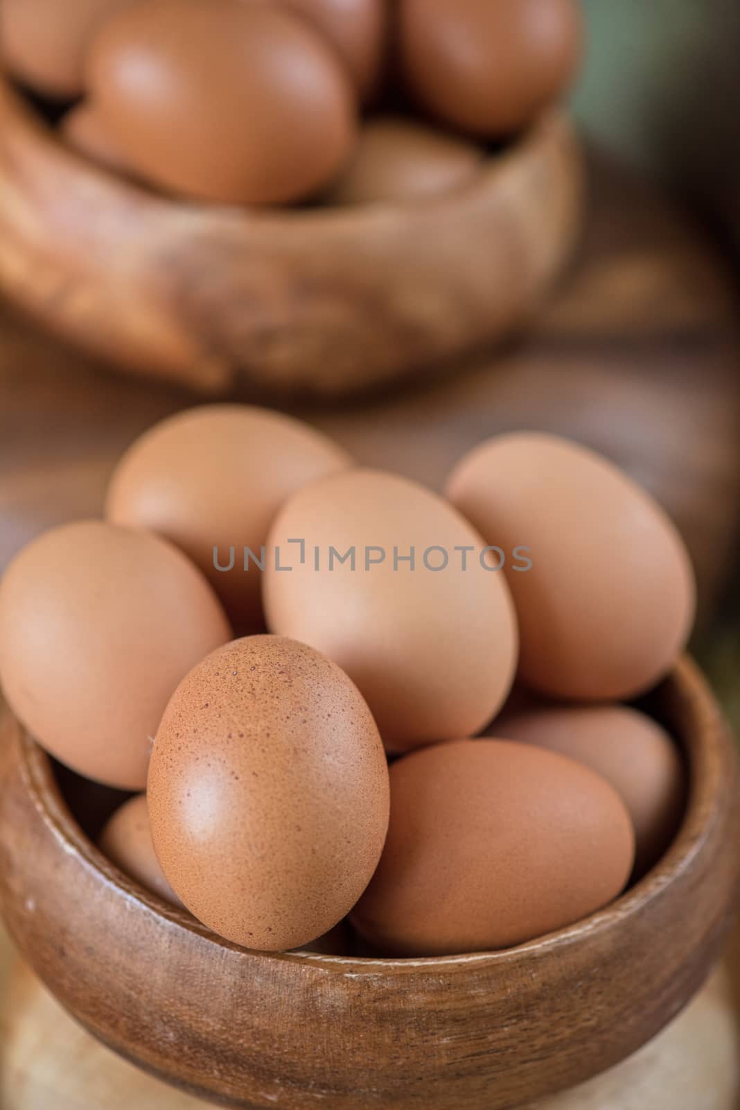 Fresh eggs at wooden plate closeup