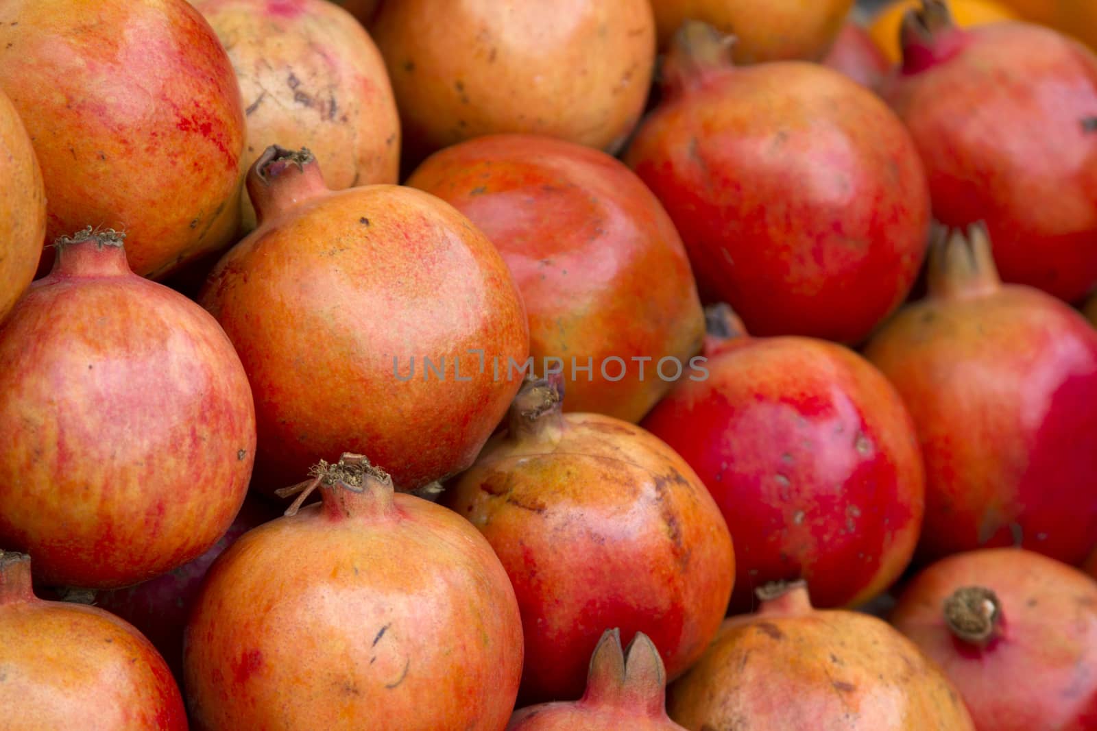 Fresh juicy pomegranate on a counter in the market of India of Goa by mcherevan