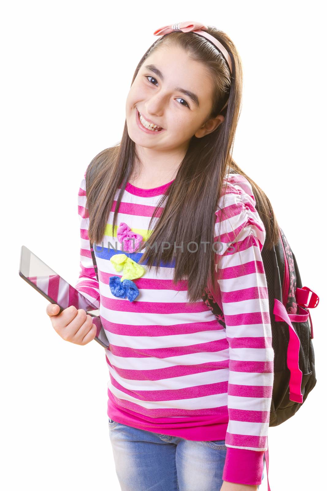 beautiful teenager girl in casual clothes with backpack holding digital tablet in her hand