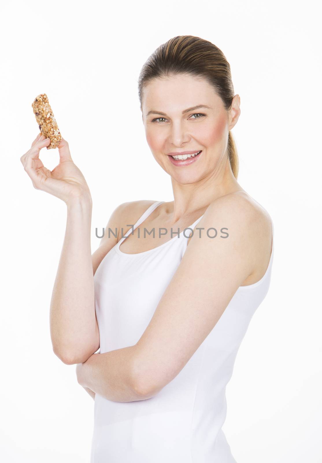 woman with white dress holding a healthy fruit bar