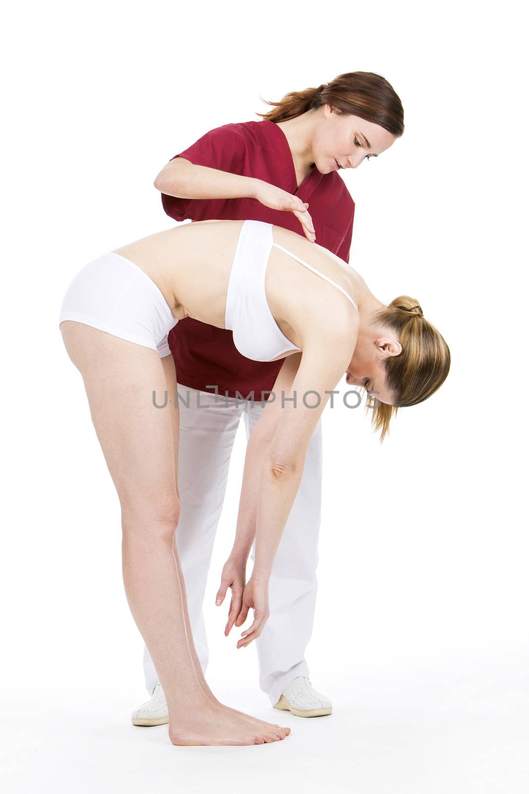 physiotherapist doing a physical examination of a woman