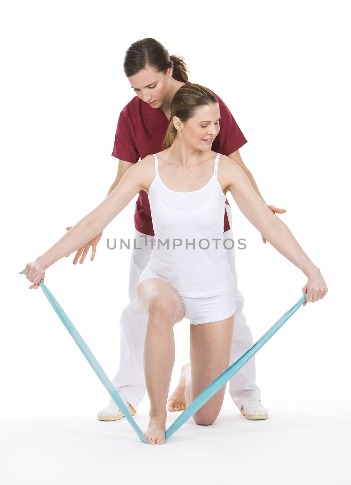 woman with physiotherapist reinforcing arms with rubber bands