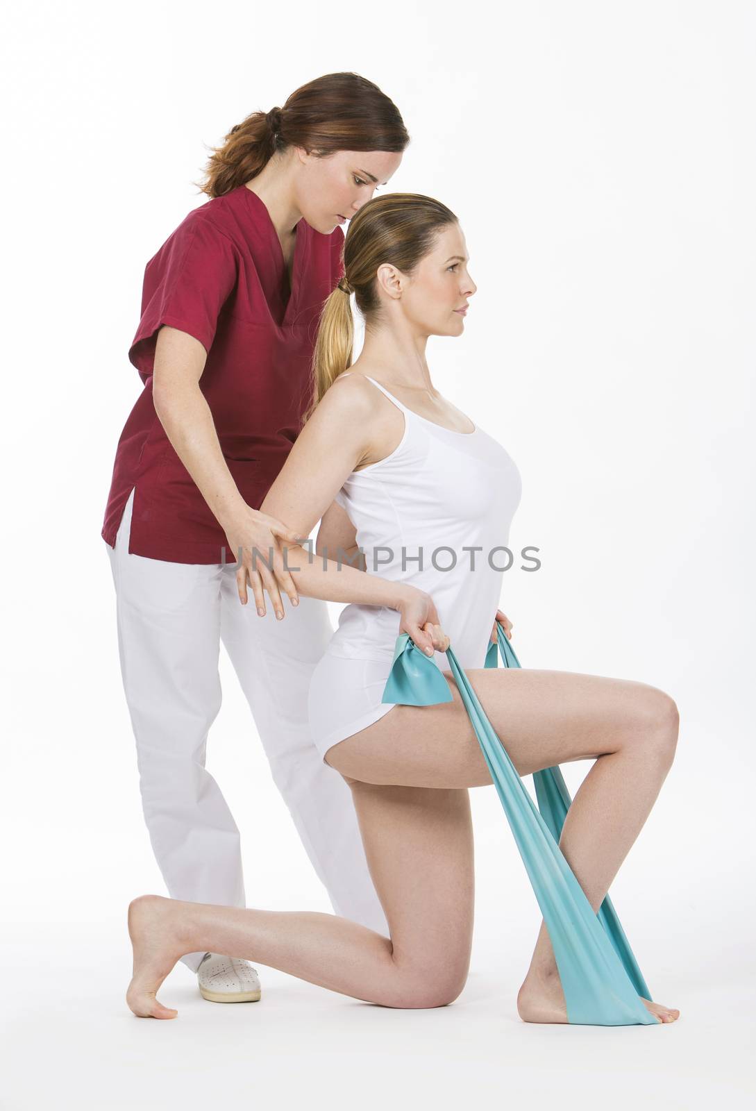 woman with physiotherapist reinforcing arms with rubber bands