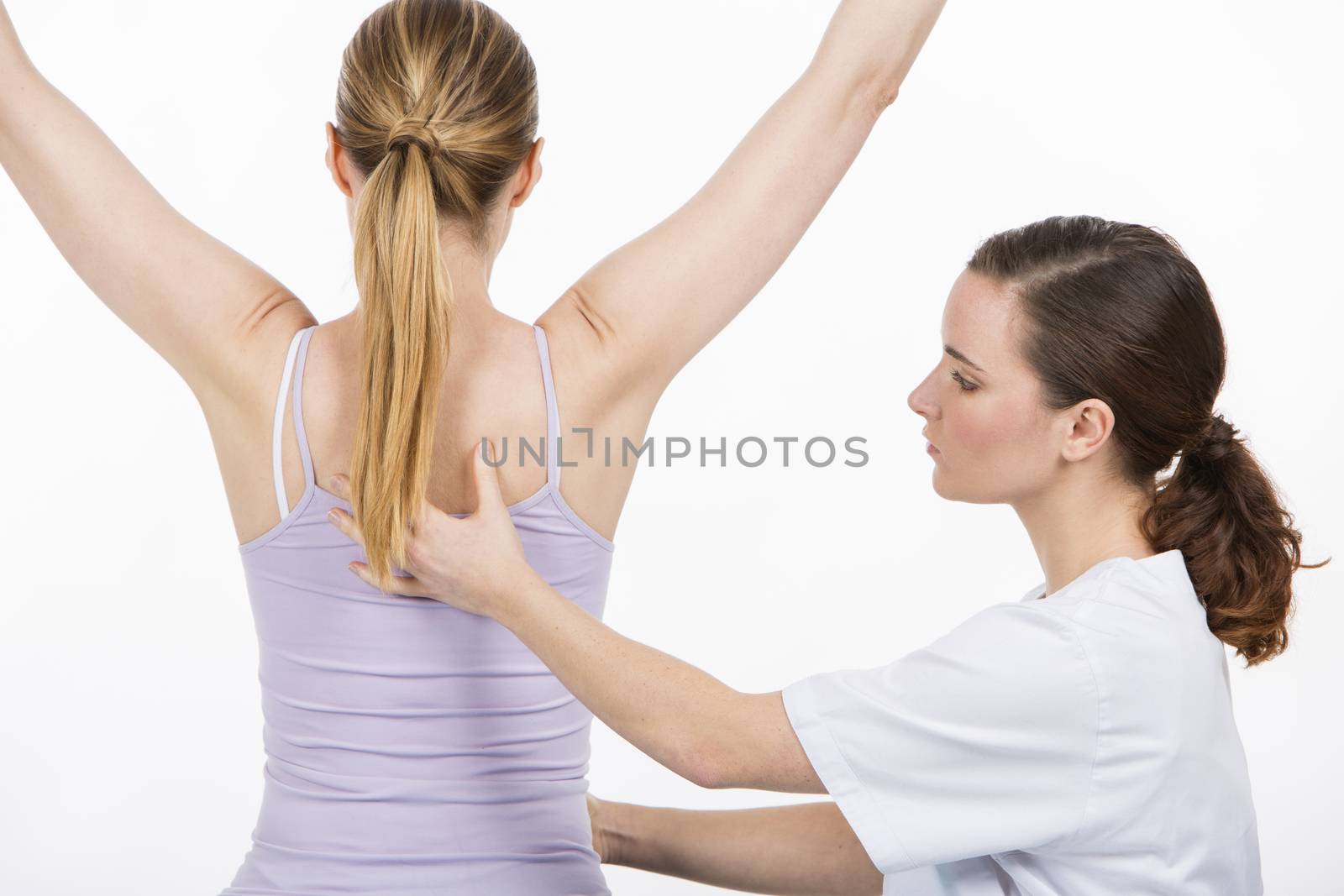 woman with physiotherapist exercising and reinforcing the vertebral column