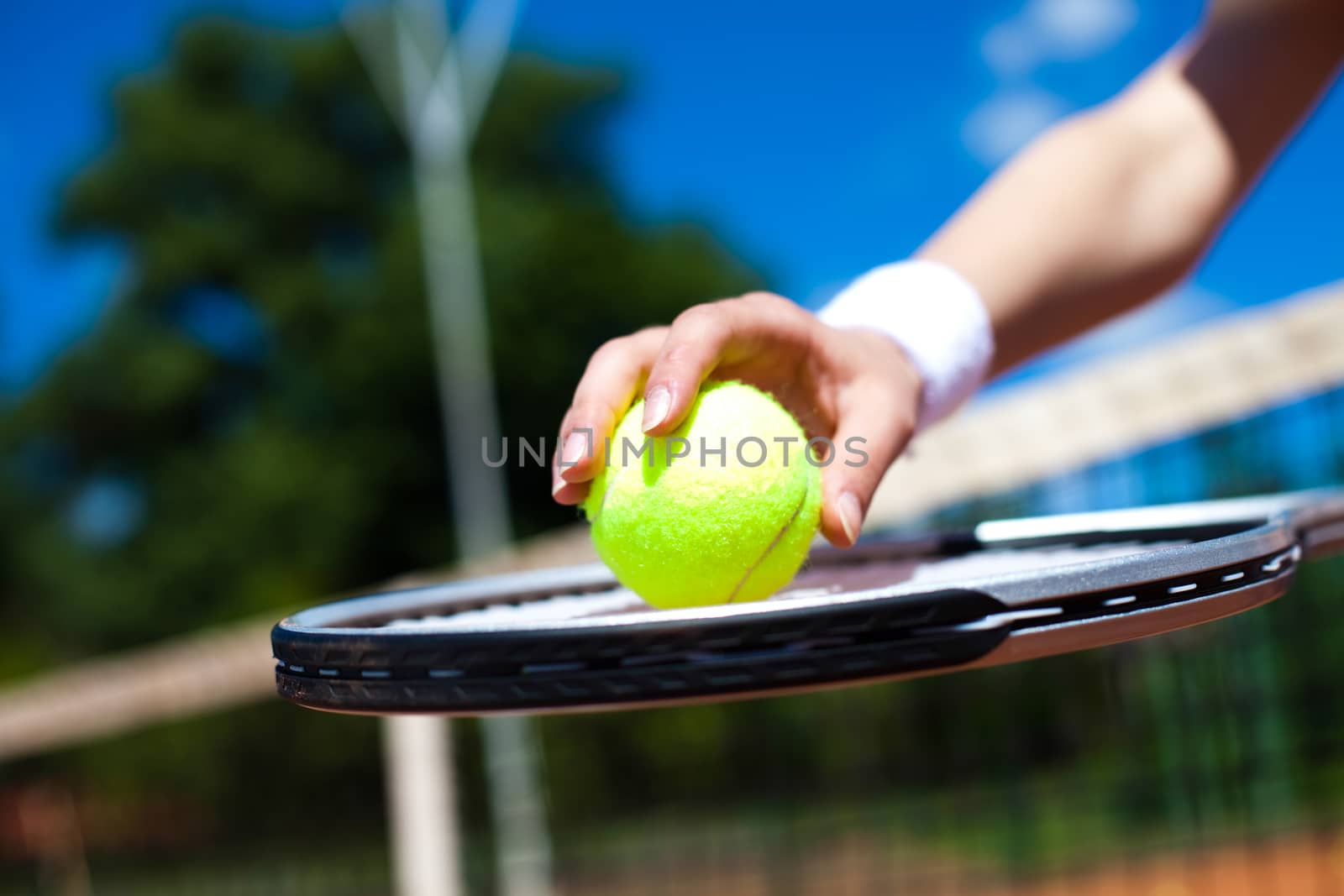 Woman playing tennis, summertime saturated theme