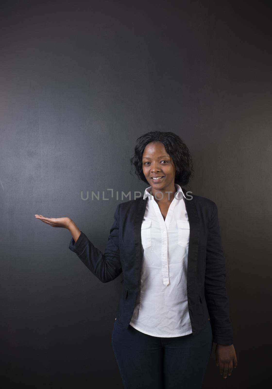 South African or African American woman teacher on chalk black board background by alistaircotton