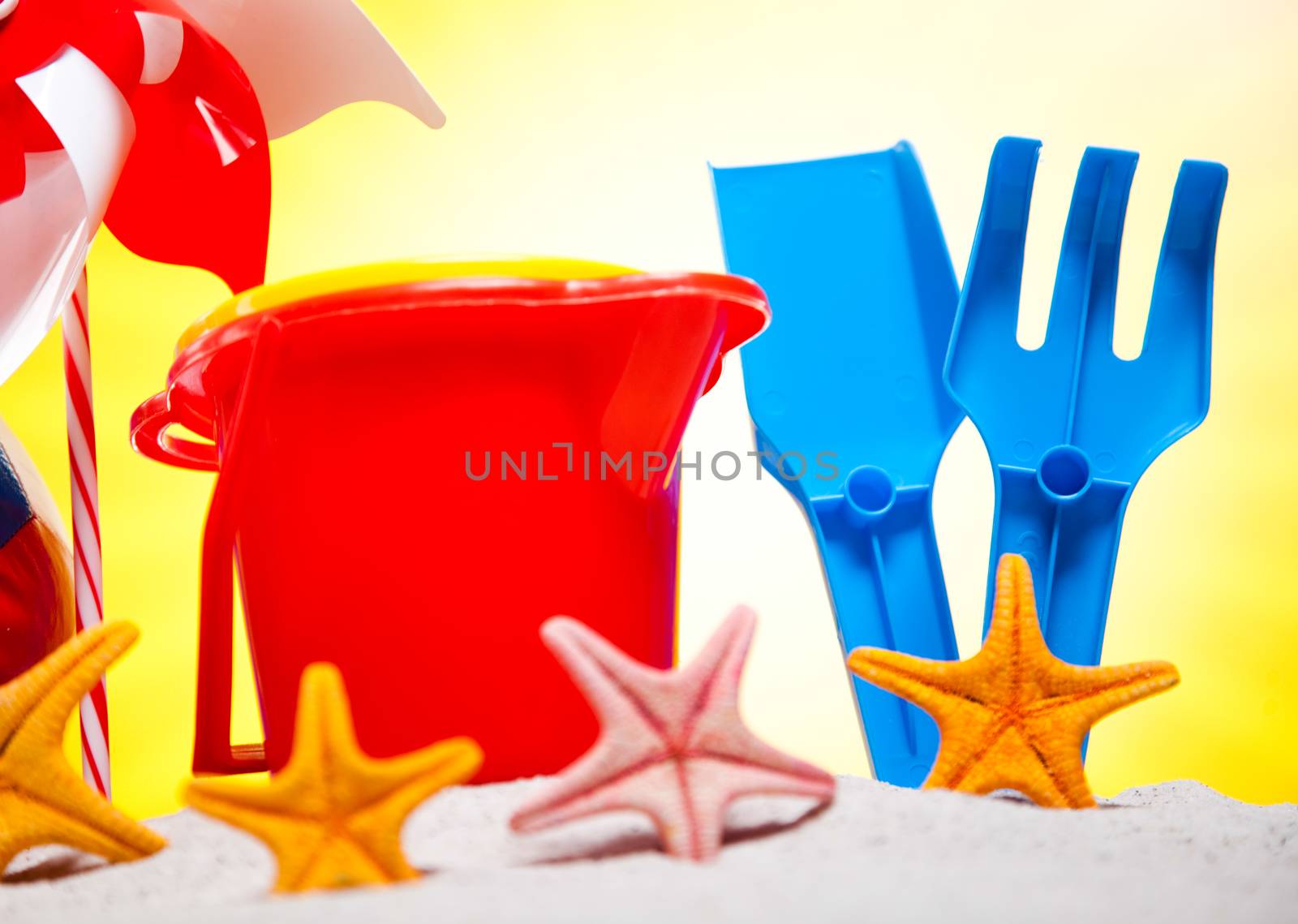 Colorful plastic toys on the beach