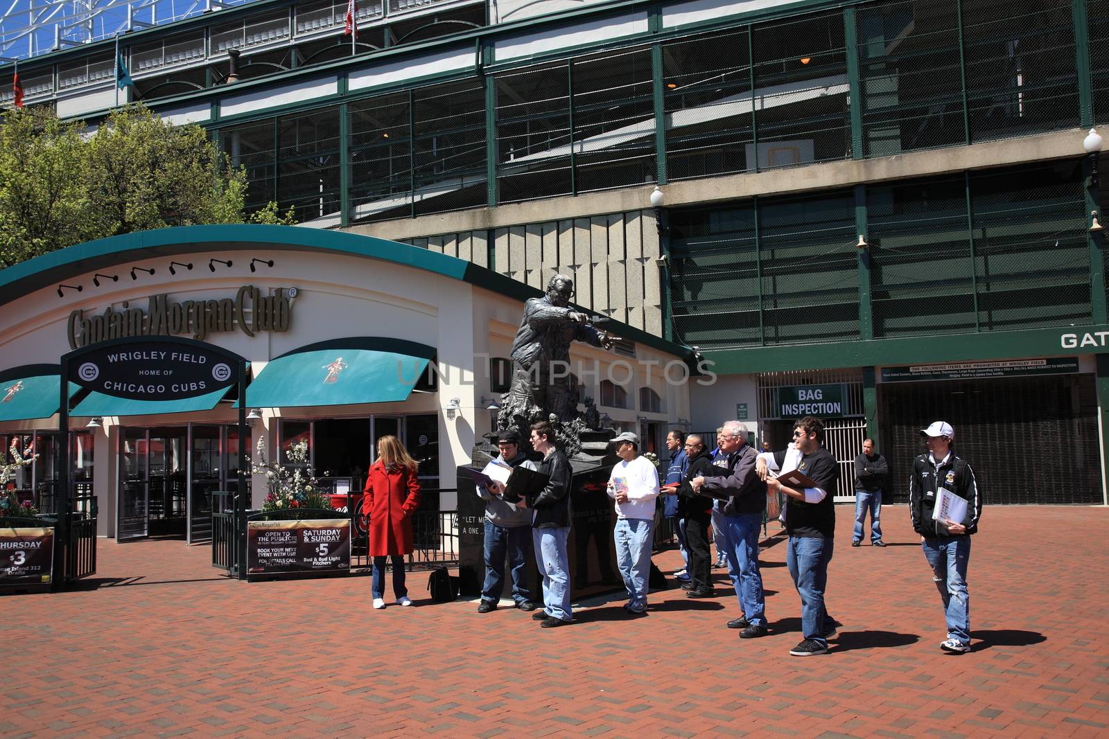 Tour group at corner of Addison Street and Sheffield Avenue, famous address for Wrigley Field, home ballpark of the Chicago Cubs.