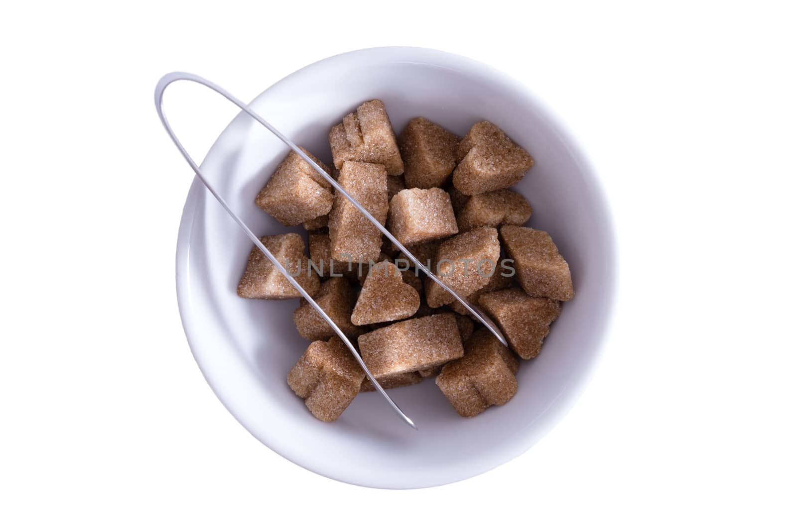 Brown sugar cubes in a bowl by coskun