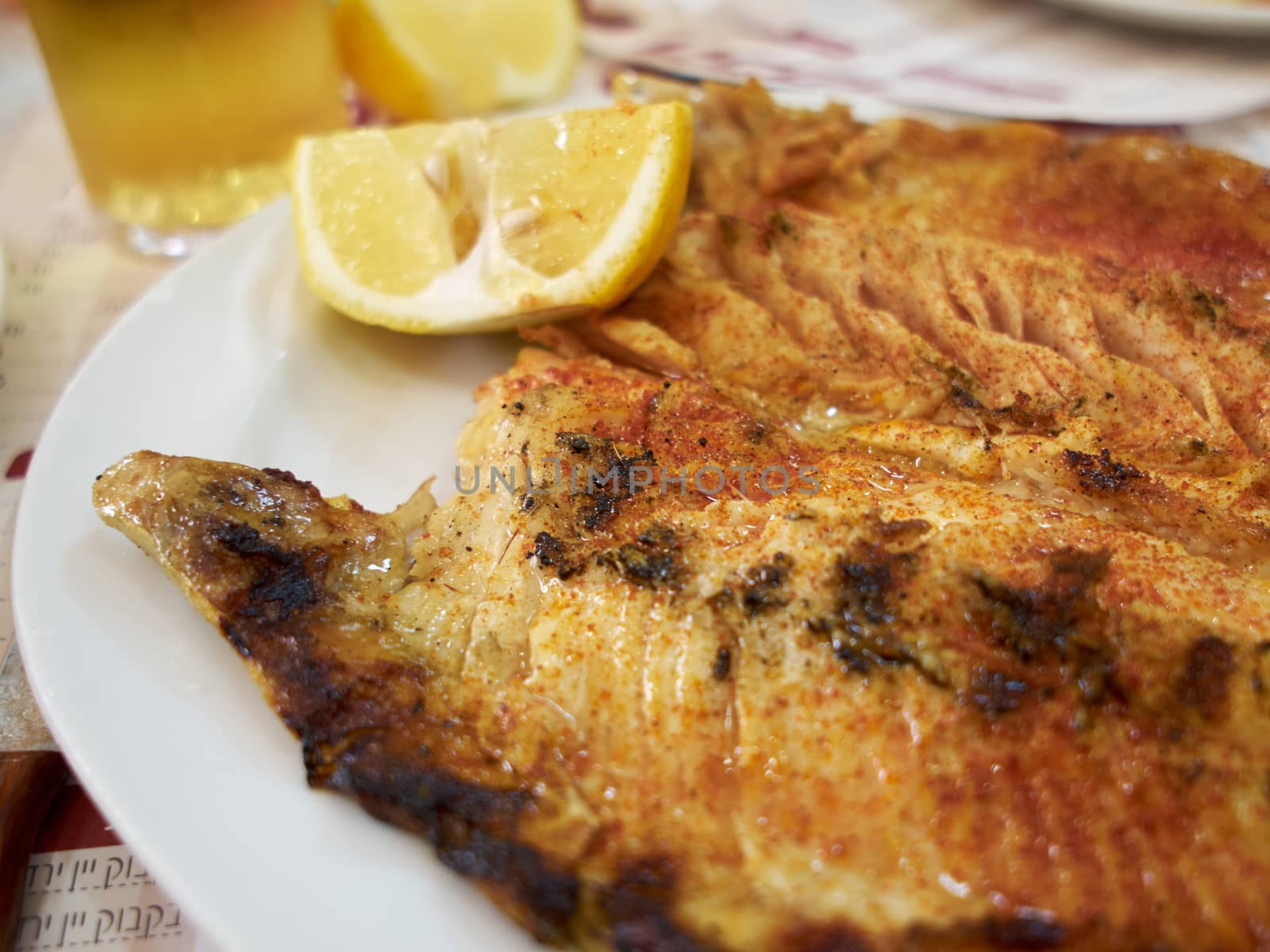 Tasty fresh grilled BBQ Trout fish served with lemon  