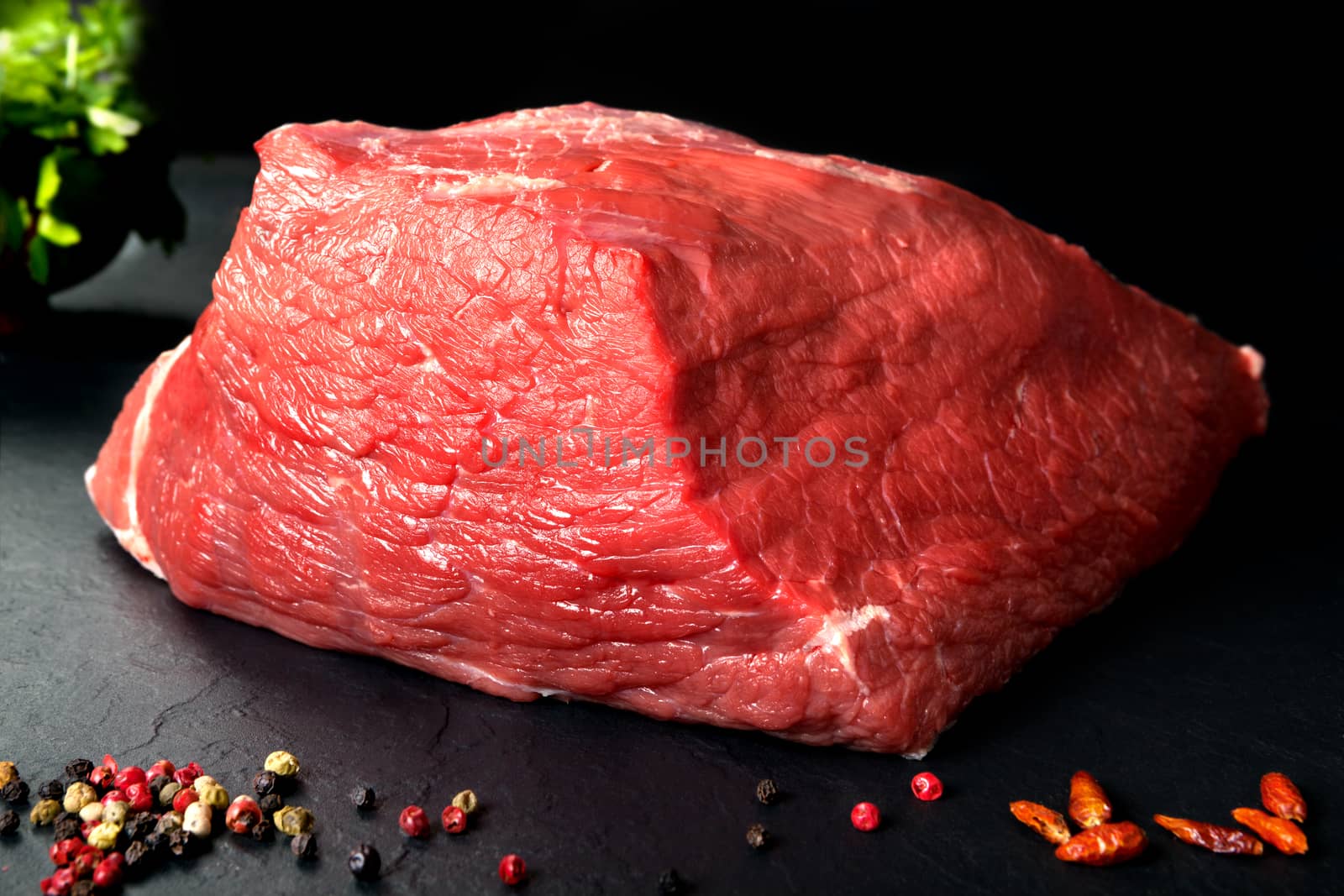 Pork uncooked fresh beef and veal. Fresh red meat spiced black stone background