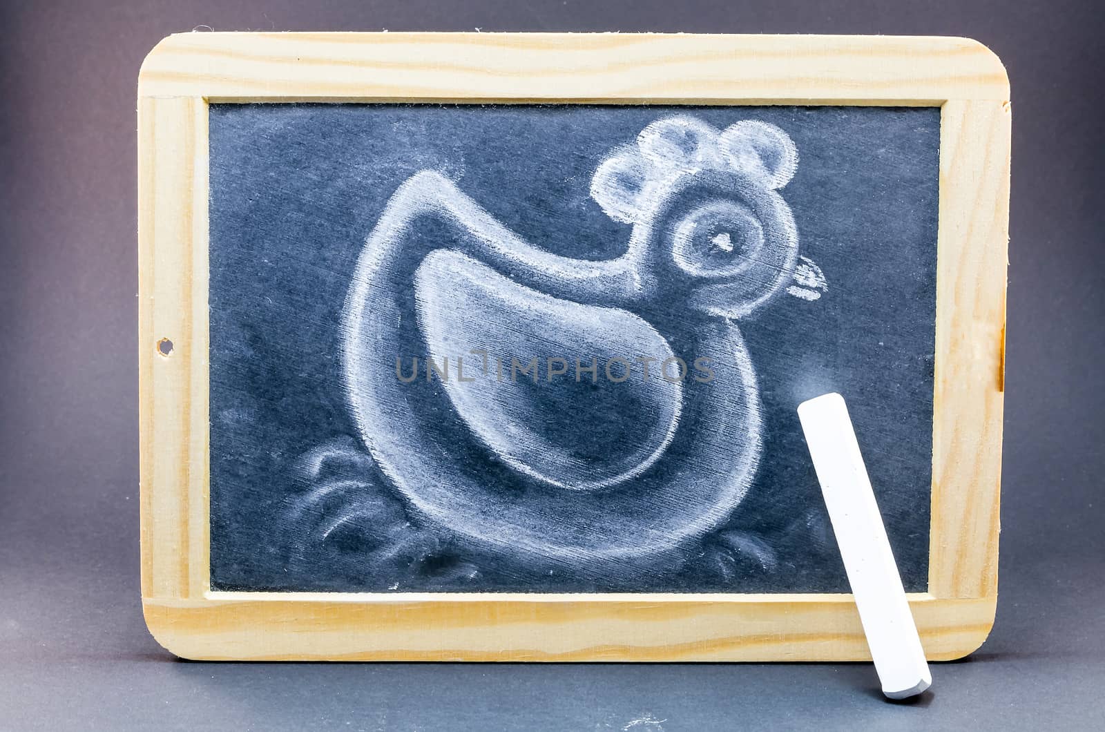 Blackboard in wooden frame with a chalk drawing of a duck.