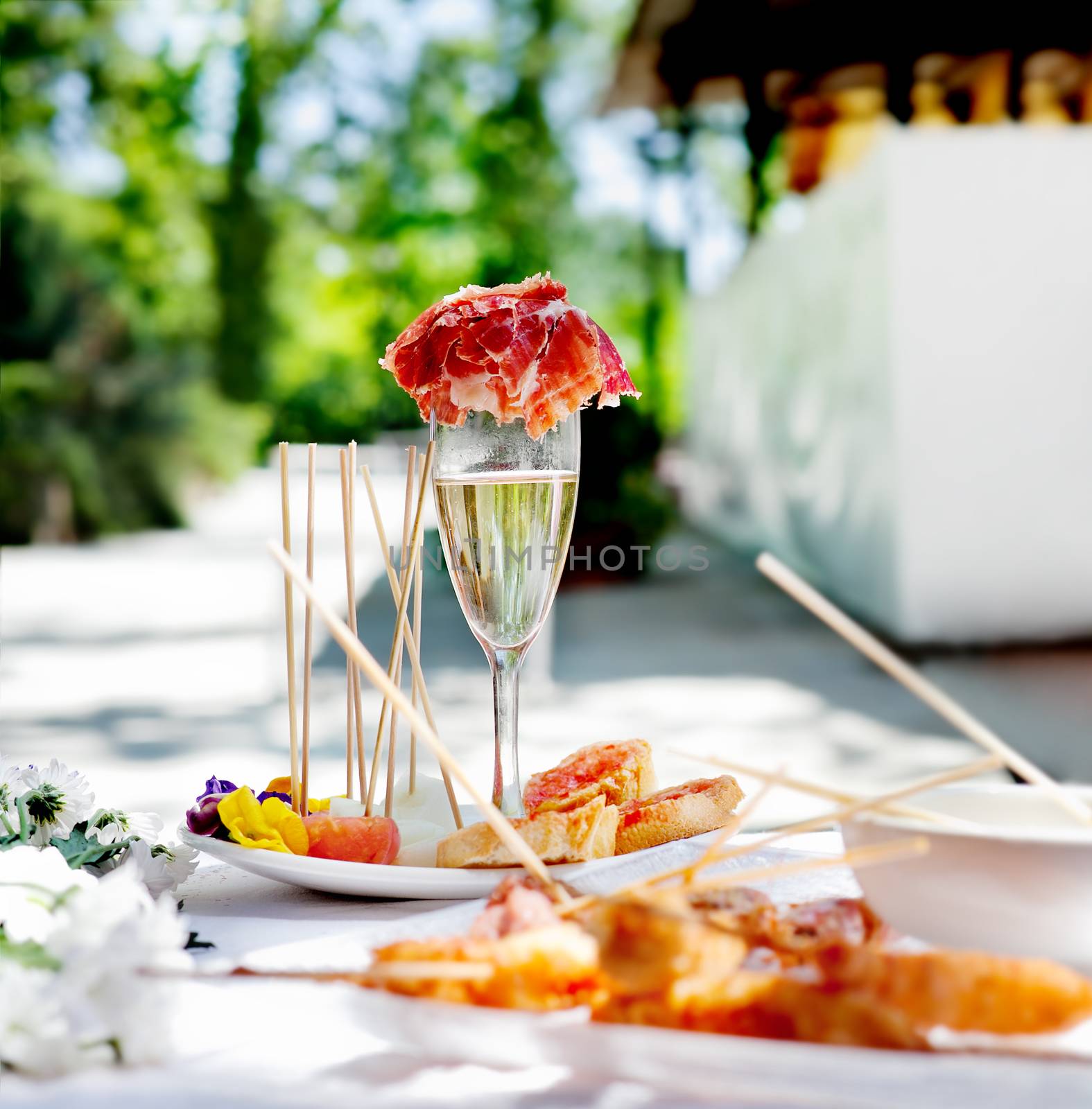 Outdoor catering. Food events and celebrations. Sliced ham and toast with champagne by Ainat