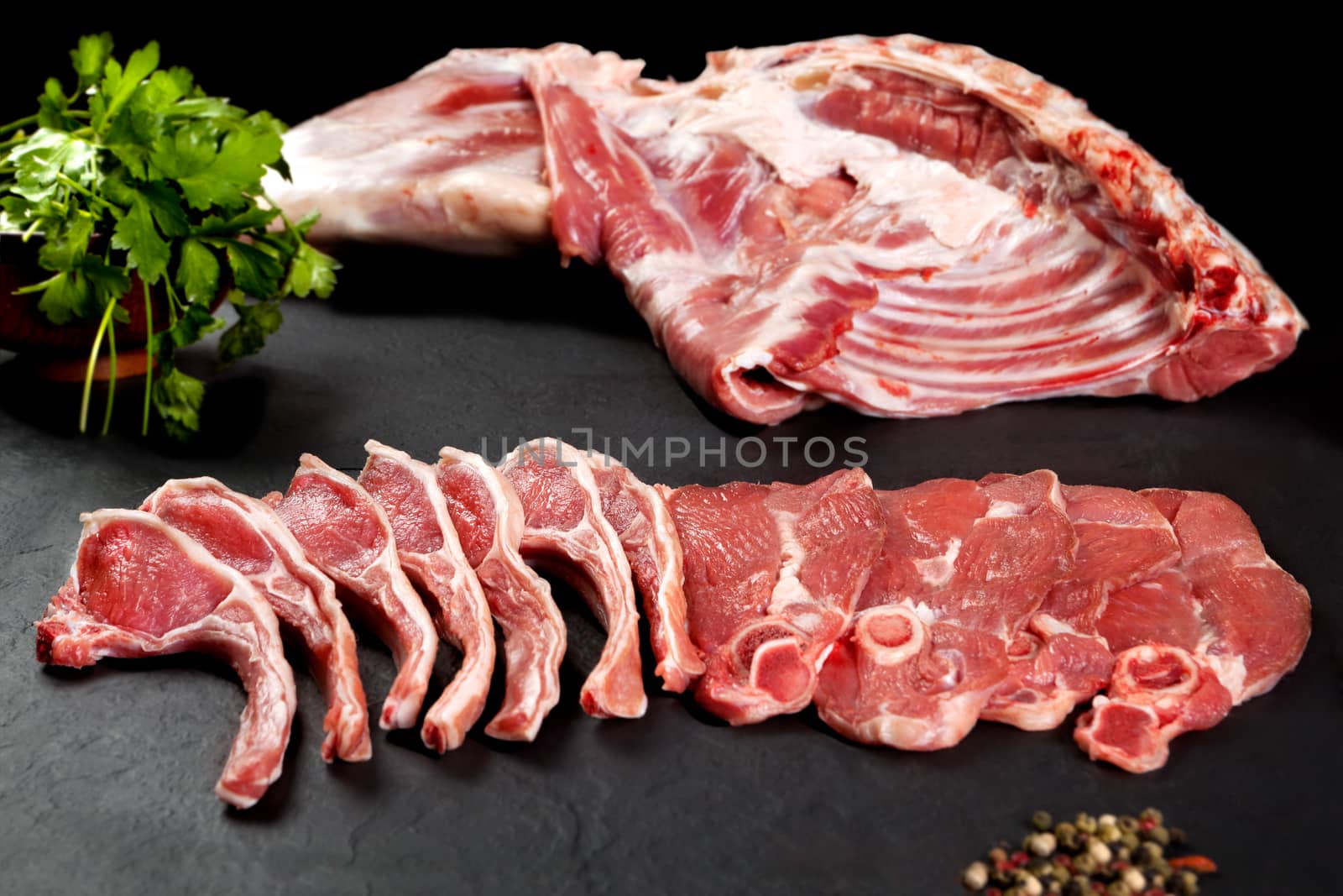 Fresh and raw meat. Ribs and pork chops uncooked, ready to grill and barbecue by Ainat