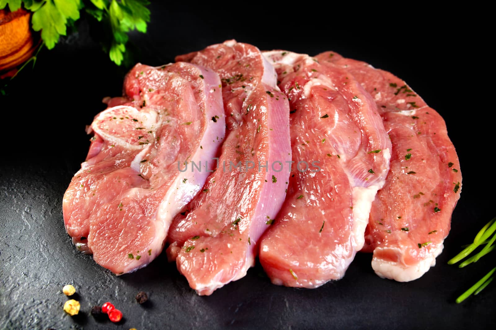 Fresh and raw meat. Turkey breast fillets in a row ready to cook. Background black blackboard. Food