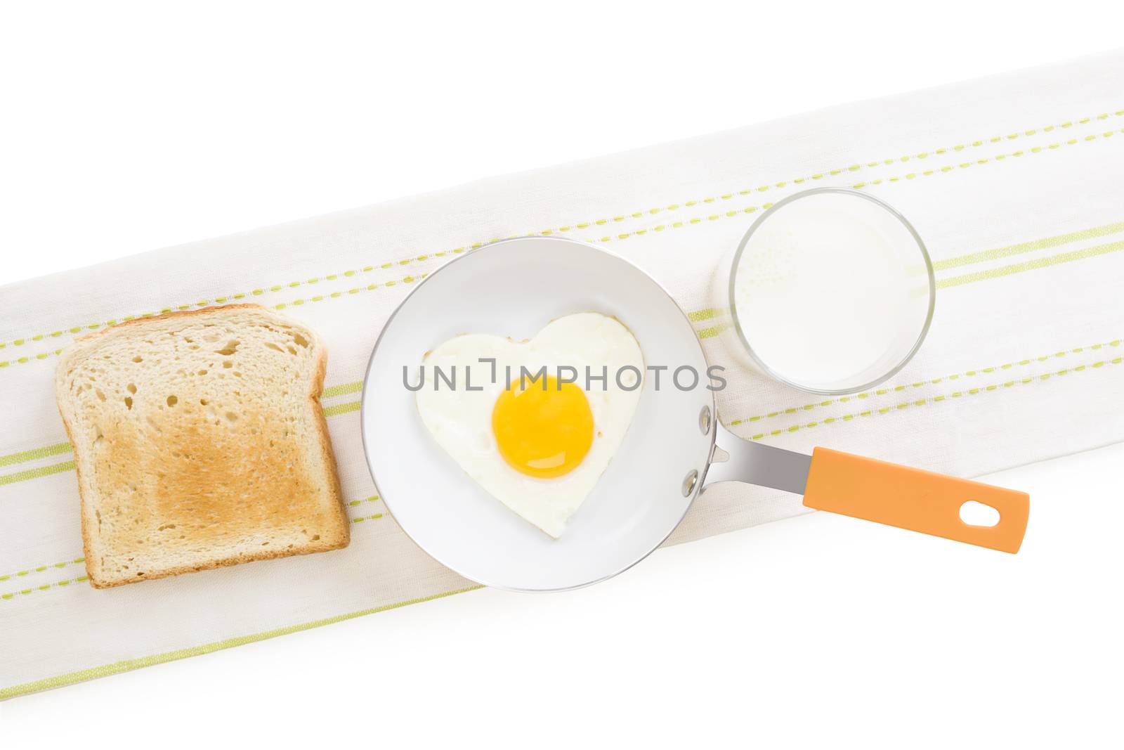 Fried egg in heart shape on pan with toast and milk, top view. I love breakfast. Fresh modern image language. Culinary arts. 