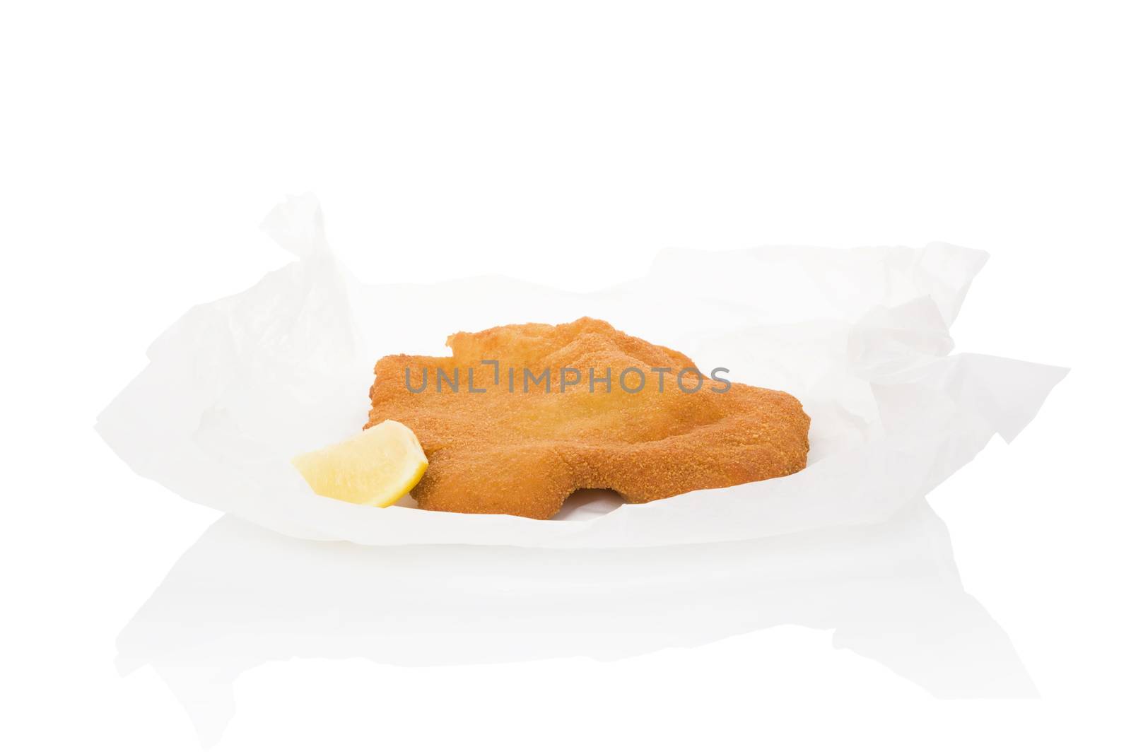 Delicious wiener schnitzel on baking paper isolated on white background. Fresh modern image language. Culinary arts. 