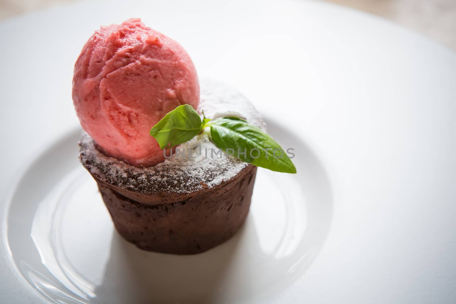 Warm dessert chocolate cake Fondant served on plate with ice-cream ball
