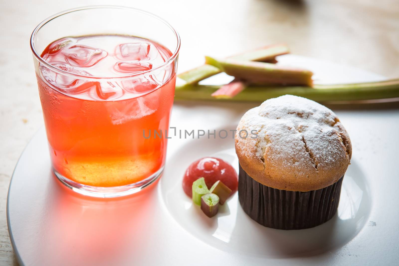 Rhubarb and ginger muffins on white plate