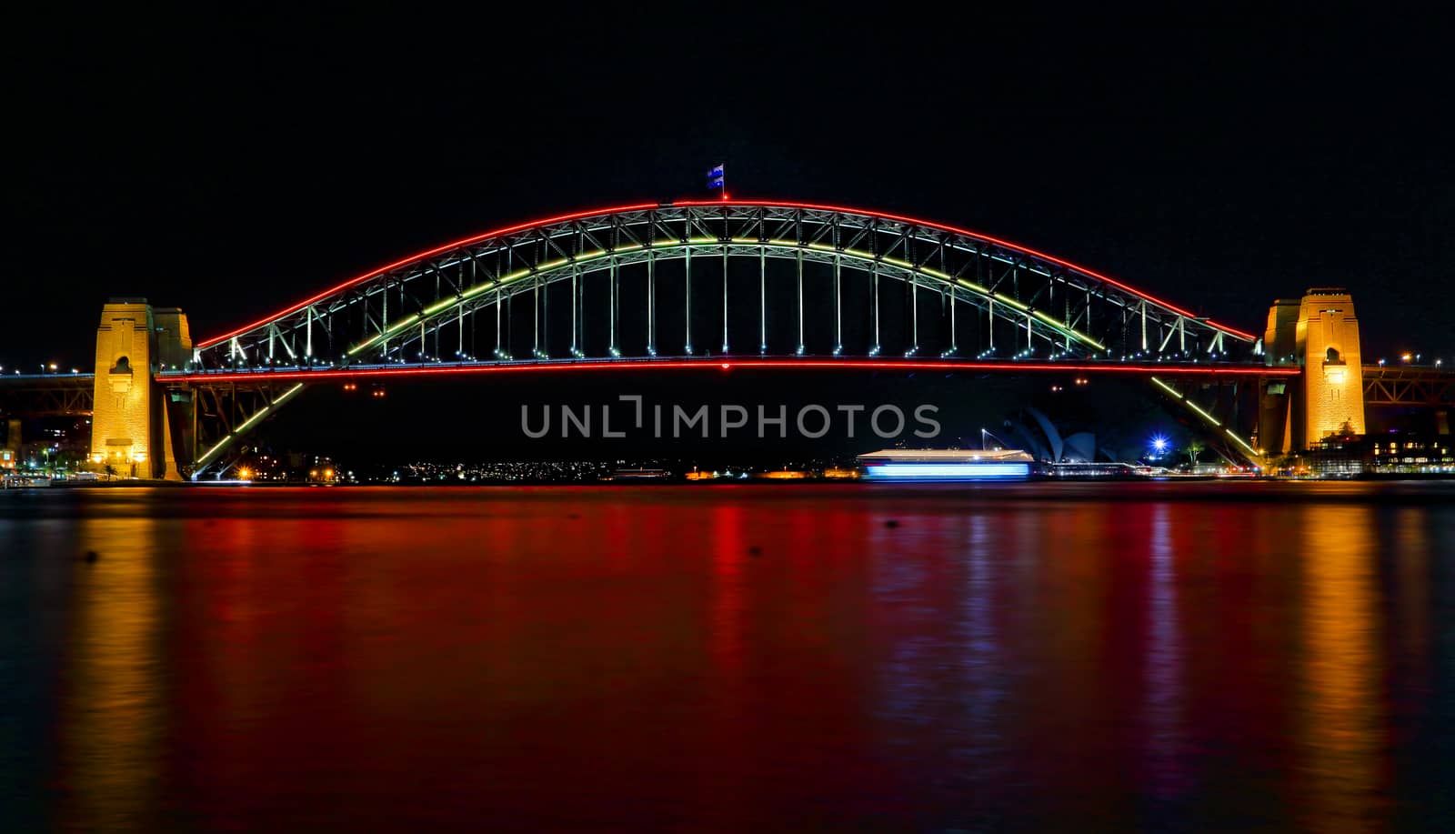 SYDNEY, AUSTRALIA - MAY 21, 2015;  Sydney Harbour Bridge lights up in vivid reds for Vivid Sydney 2015 and a harbour of vivid red water as well