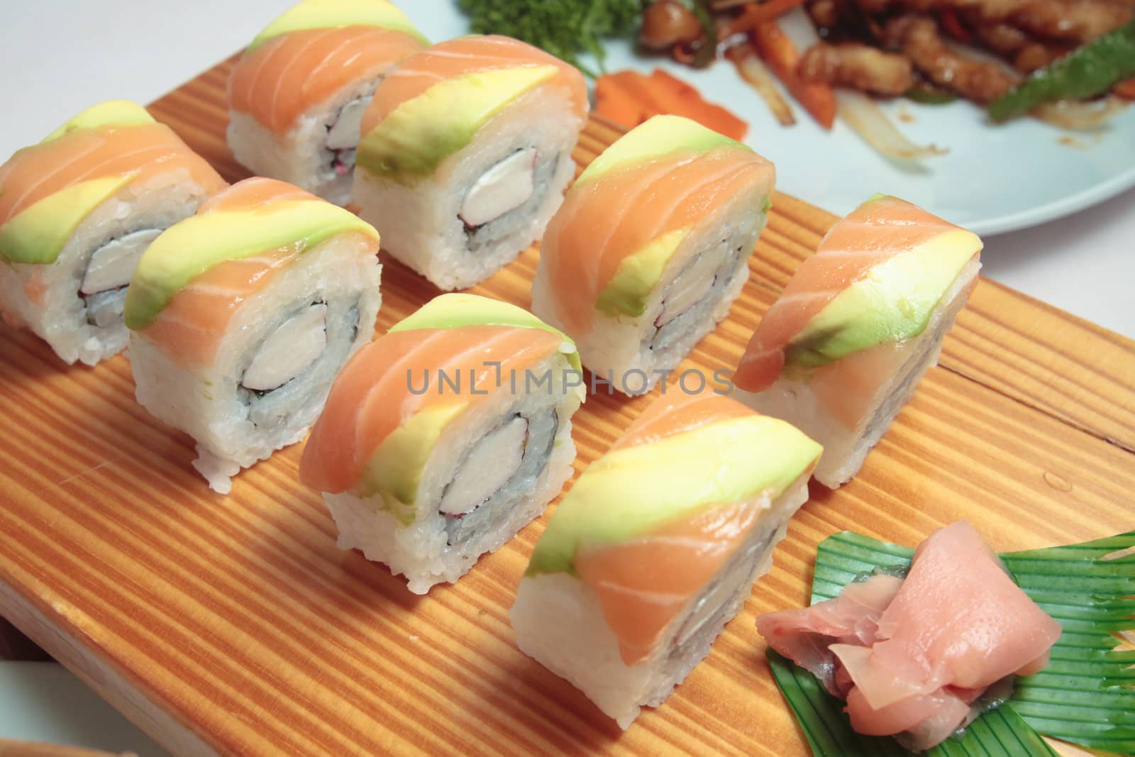 salmon sushi on wooden plate close up