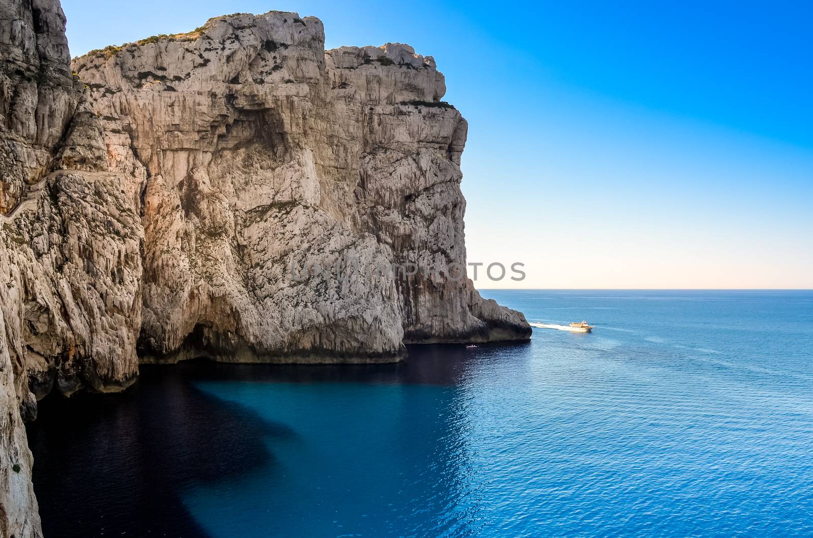 Ocean rocky landscape with the boat, near Neptune's cave, Sardin by martinm303