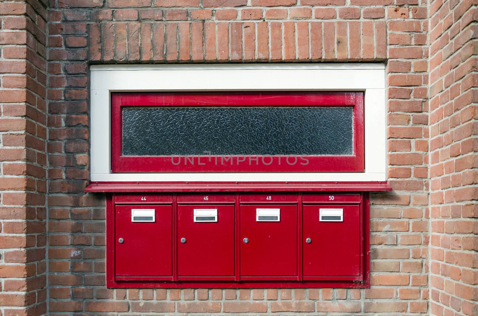 Mailbox and window outside apartment building by siraanamwong