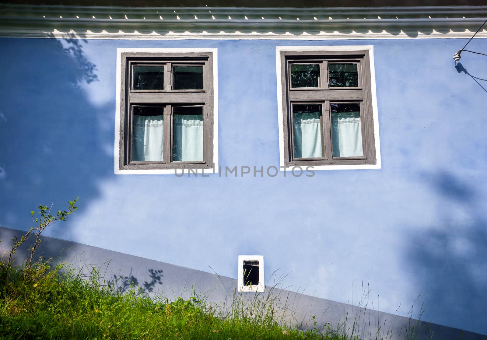 Viscri, Romania - June 23, 2013: Blue painted traditional house from Viscri village in Transylvania, Romania