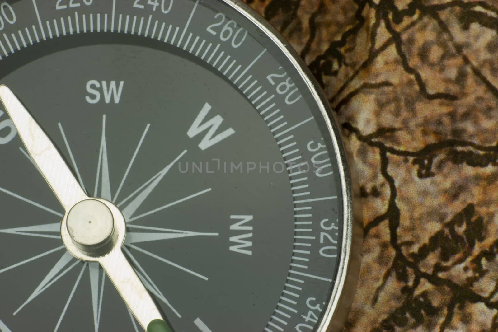 Close up of a compass on an old map