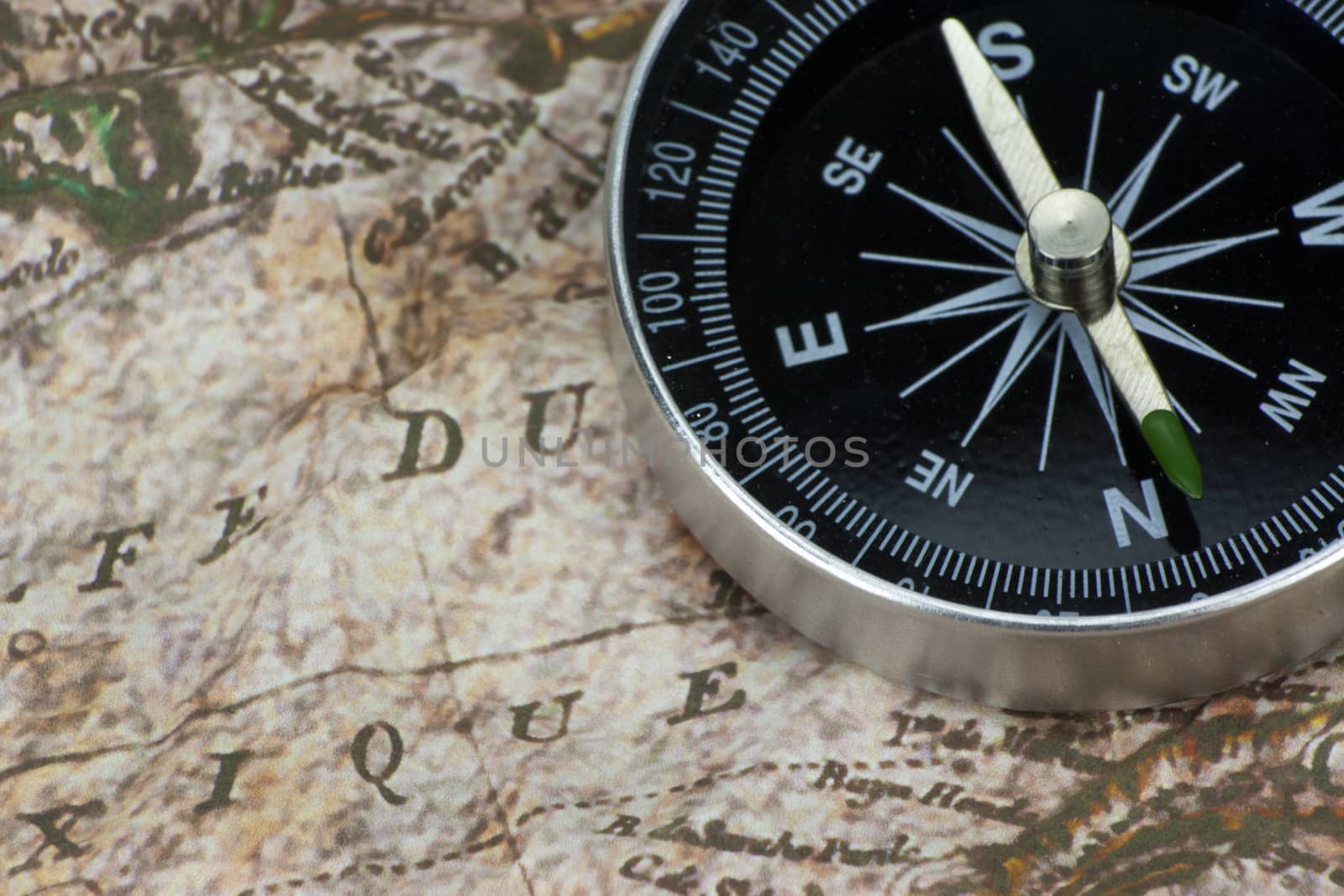 Close up of a compass on an old map