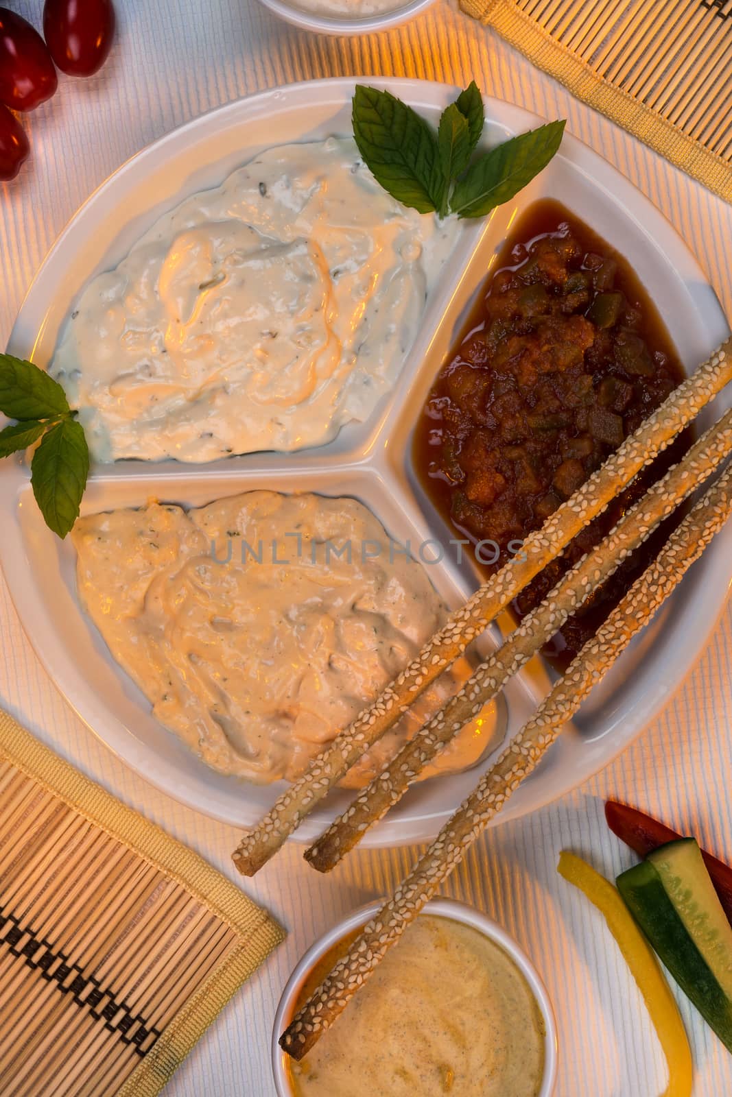 A selection of party dips with bread sticks and other crudites.