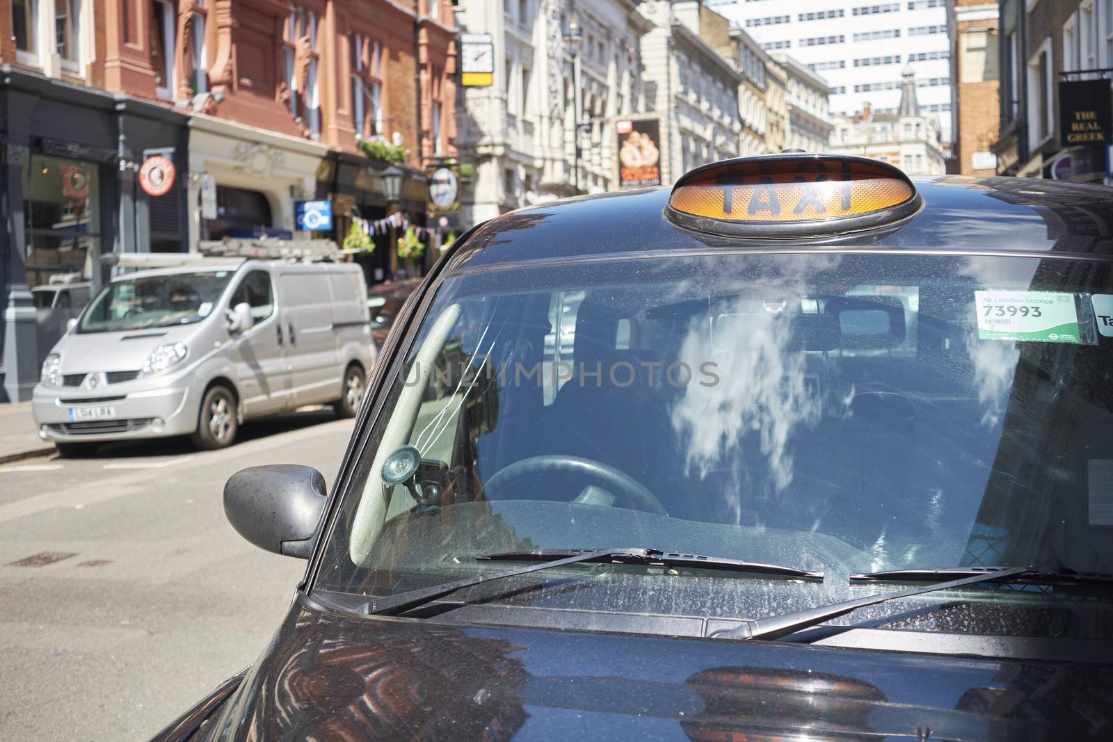 LONDON, UK - MAY 13: Detail famous black cab in street on sunny day. May 13, 2015 in London.