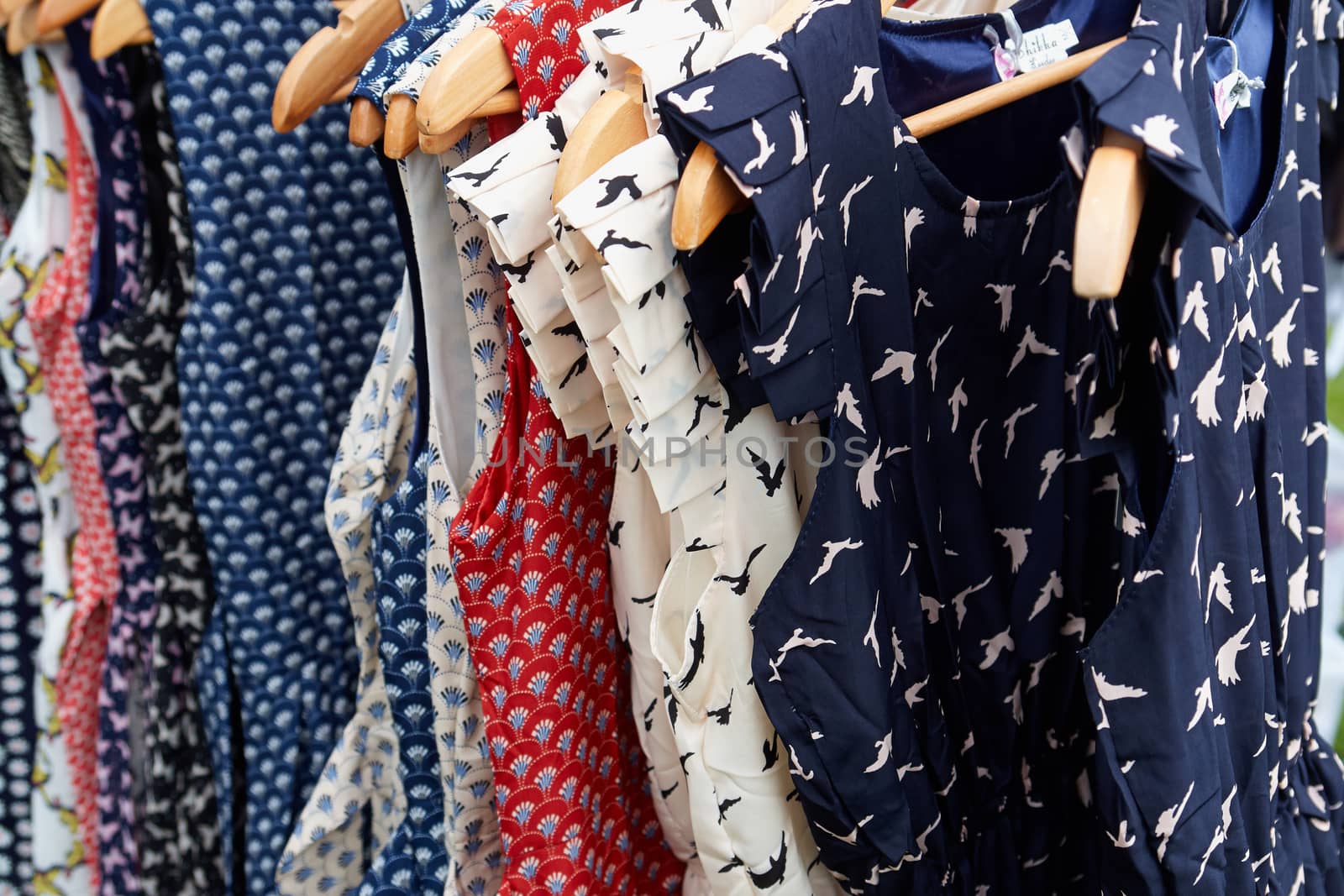 Colorful Rockabilly polka dot dresses on hangers display                               