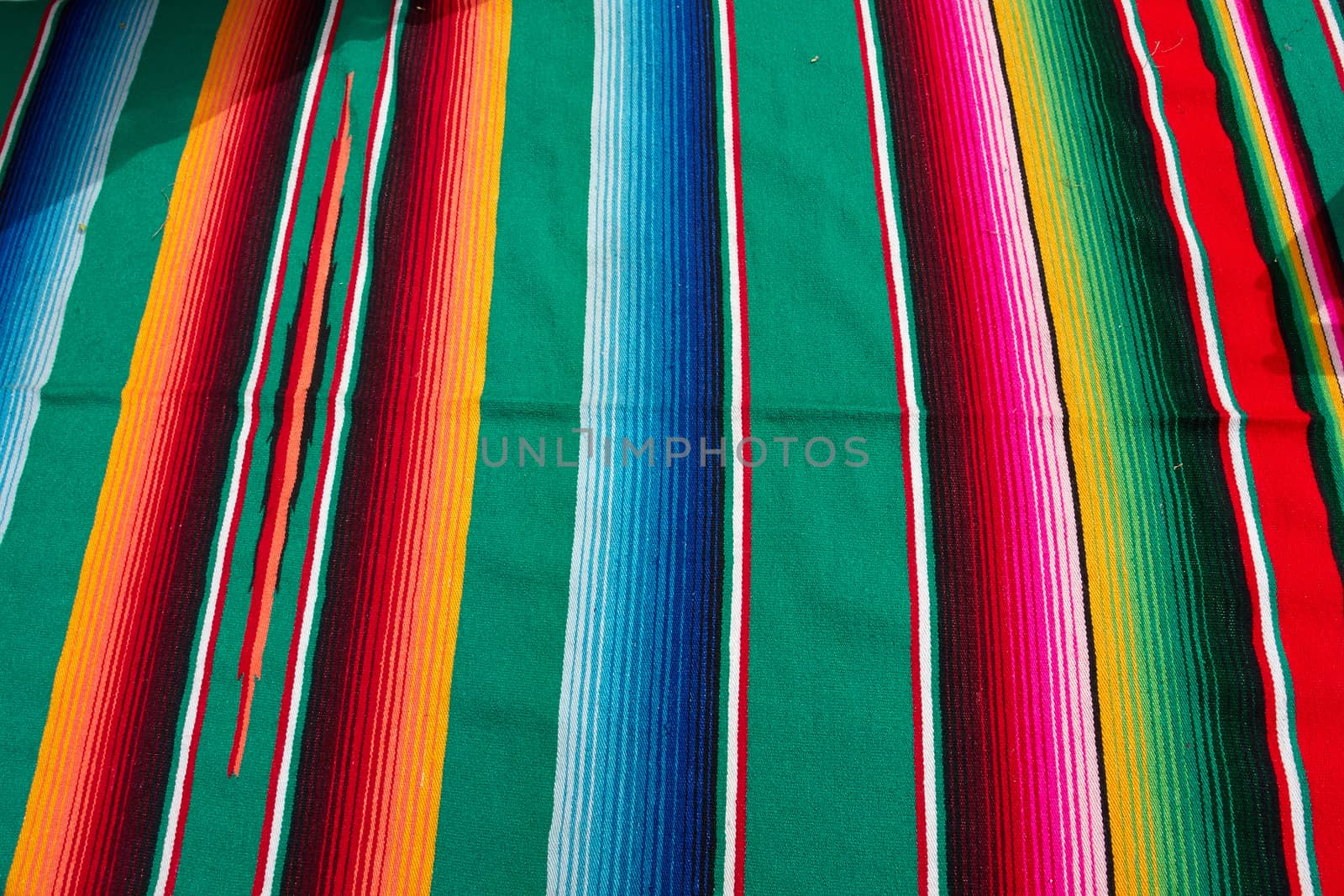 Typical traditional colorful Mexican festive fabric cloth on display                               