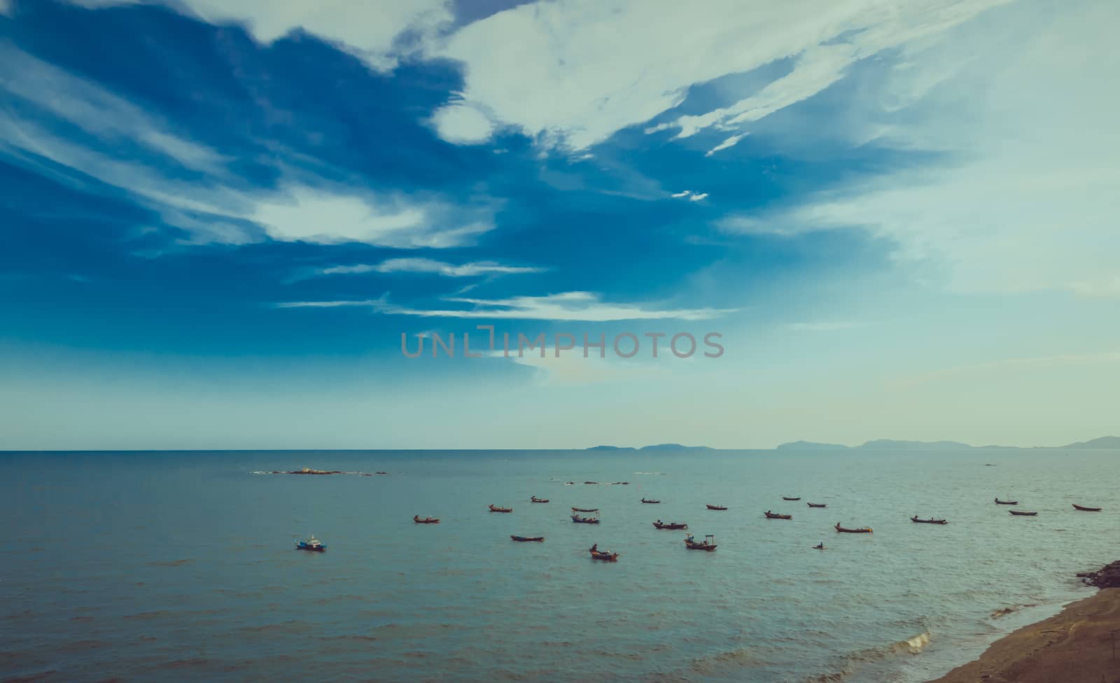 Small group of sail boats on blue sky background.